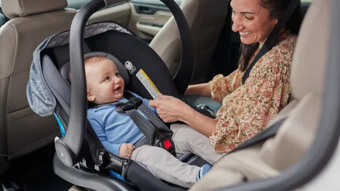 Infant car seat installed in a vehicle back seat