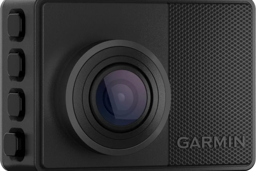 Compact Garmin Dash Cam 67W with rear display showing a recorded road view